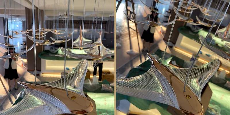 Close-up views of repeated wing-like units used for custom staircase lighting Close-up views of repeated wing-like units used for custom staircase lighting