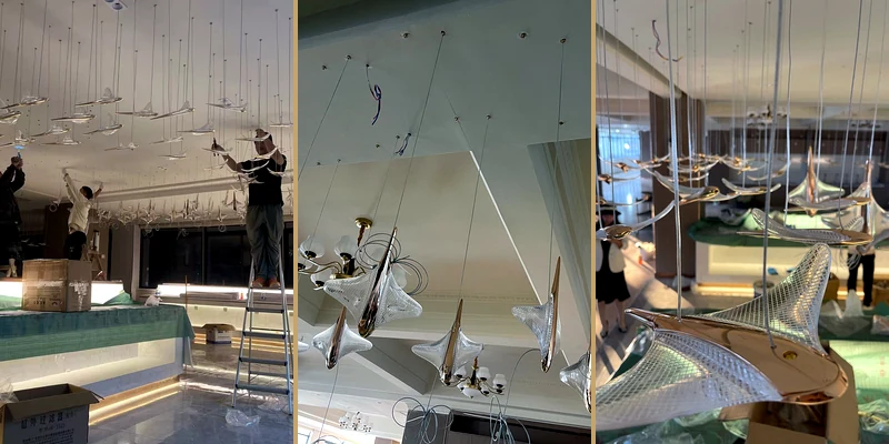Multi-view installation record of a hotel staircase chandelier with staggered wing-like units Multi-view installation record of a hotel staircase chandelier with staggered wing-like units