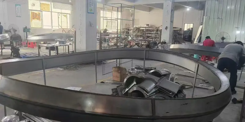 Large curved metal frame under fabrication for a custom artistic chandelier