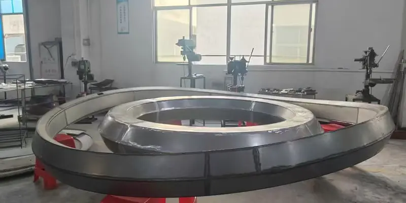 Curved metal chandelier modules arranged for trial fitting and quality control