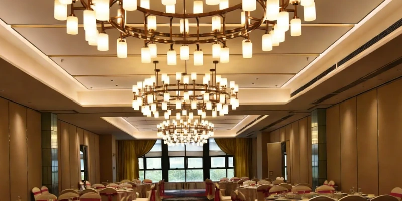 Matching multi-tier chandeliers above round tables in a hotel banquet hall Matching multi-tier chandeliers above round tables in a hotel banquet hall