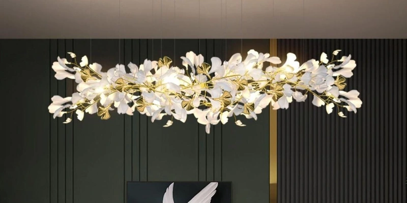Suspended white leaf chandelier with gold accents in a dark green interior Suspended white leaf chandelier with gold accents in a dark green interior