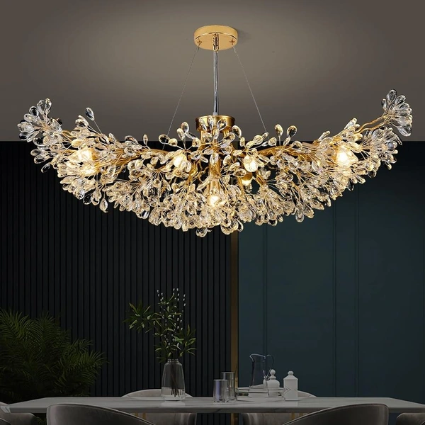 Curved gold-tone chandelier with clear decorative elements and a round ceiling canopy Curved gold-tone chandelier with clear decorative elements and a round ceiling canopy