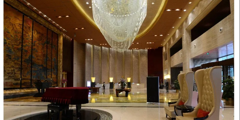 Large crystal hotel lobby chandelier creating a formal guest arrival experience